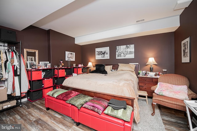 bedroom with hardwood / wood-style floors and a closet