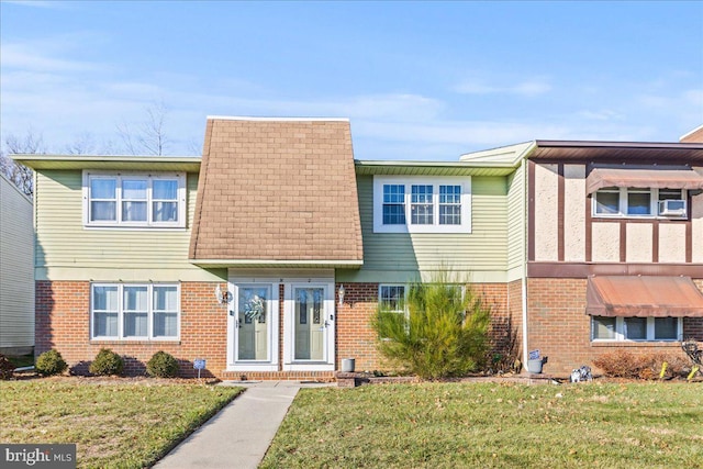 view of front of property featuring cooling unit and a front yard