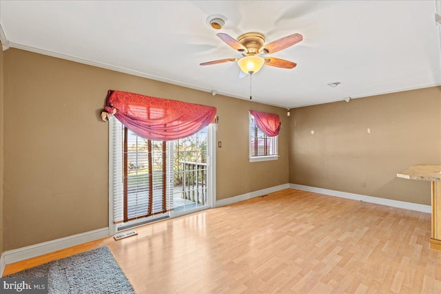 unfurnished room featuring ceiling fan, light hardwood / wood-style floors, and ornamental molding