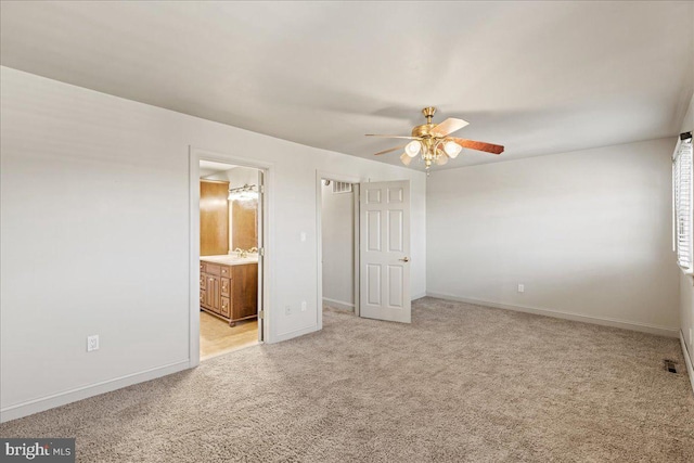 unfurnished bedroom with connected bathroom, ceiling fan, sink, and light colored carpet