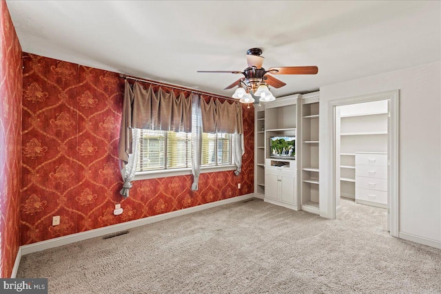 unfurnished bedroom featuring ceiling fan and light colored carpet