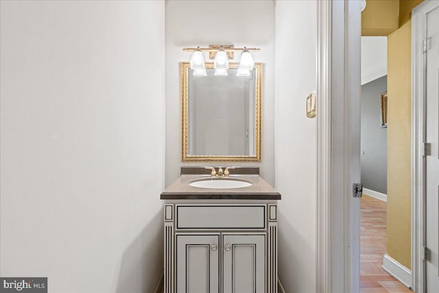 bathroom with hardwood / wood-style floors and vanity