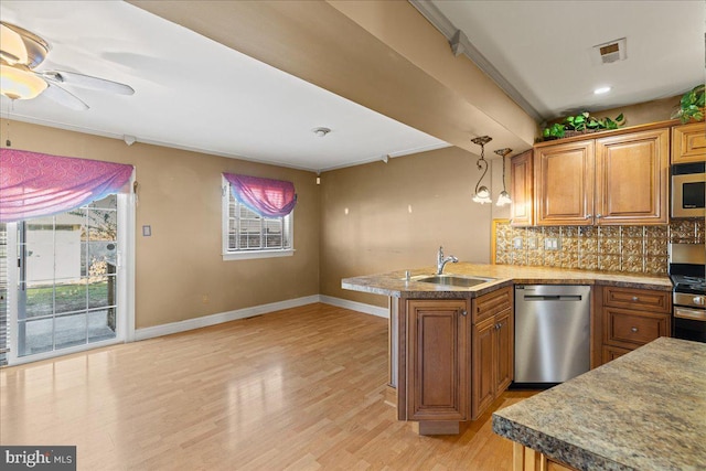 kitchen featuring light hardwood / wood-style floors, ornamental molding, sink, and appliances with stainless steel finishes