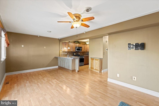 unfurnished living room featuring light wood-type flooring, ceiling fan, and crown molding