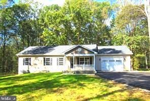 ranch-style house with a garage and a front lawn