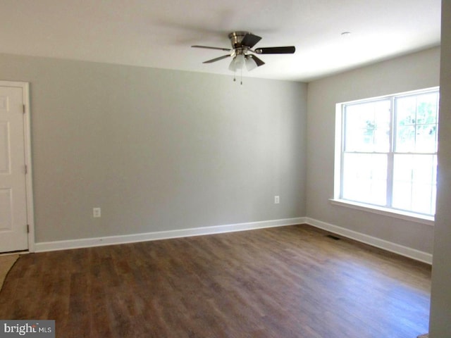 spare room with hardwood / wood-style floors and ceiling fan