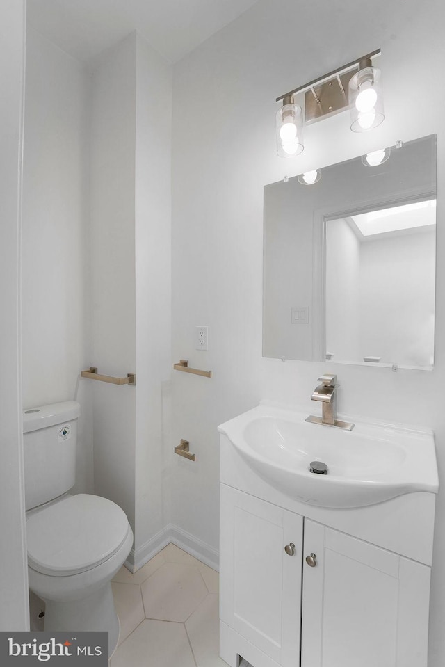 bathroom with vanity, toilet, and tile patterned floors