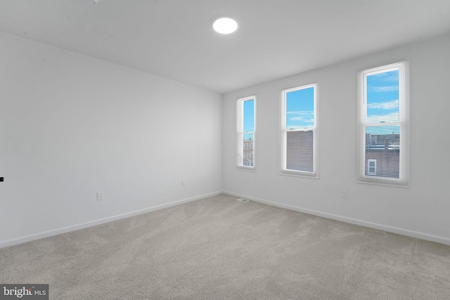 empty room featuring light carpet