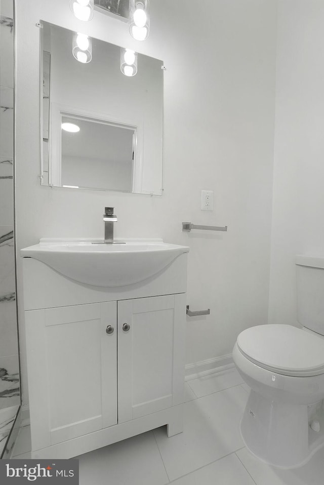 bathroom with vanity, toilet, and tile patterned flooring