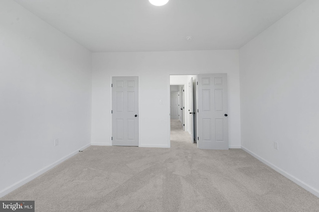 unfurnished bedroom featuring light colored carpet