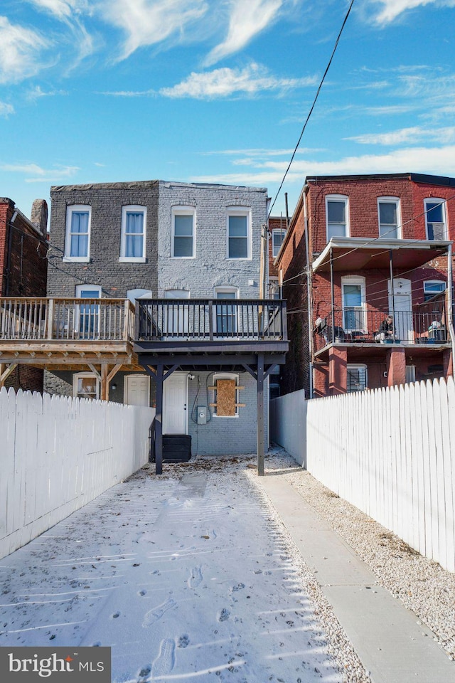 back of property with a wooden deck