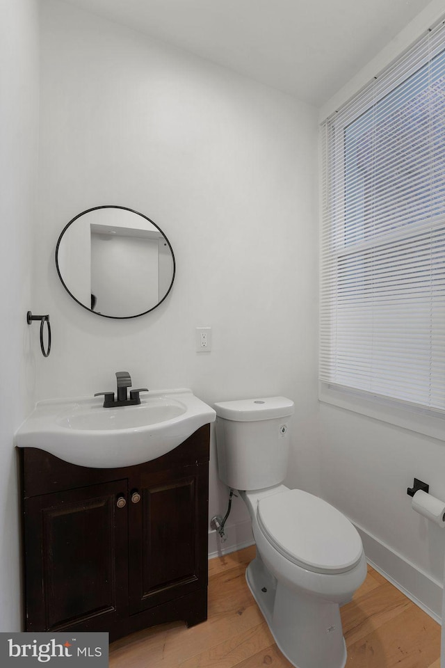 bathroom with vanity, hardwood / wood-style flooring, and toilet