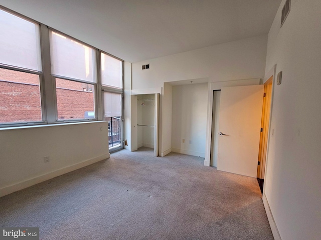 unfurnished bedroom featuring light colored carpet