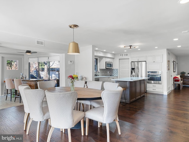 dining room with dark hardwood / wood-style floors, ceiling fan, and sink