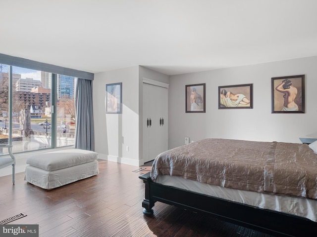 bedroom featuring hardwood / wood-style floors and a closet