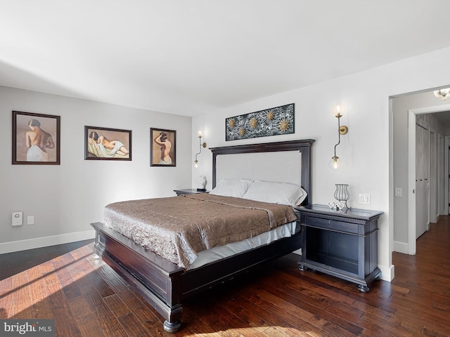 bedroom with dark hardwood / wood-style floors