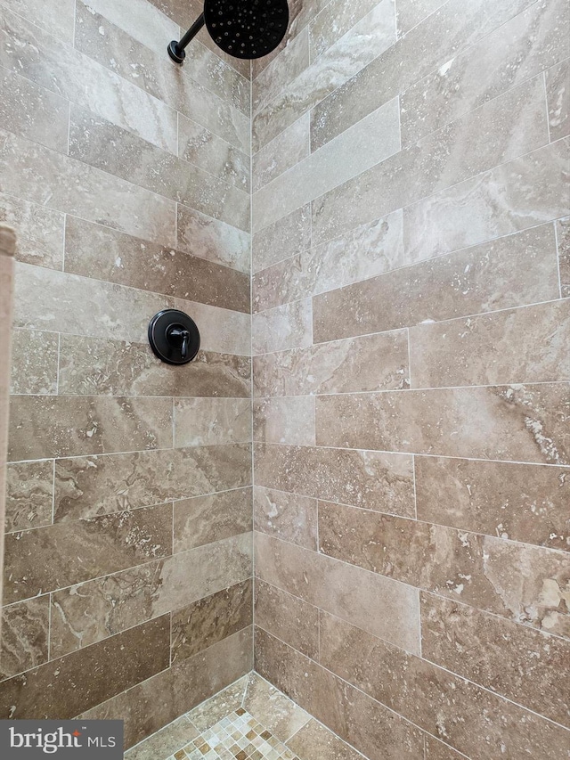 bathroom with tiled shower