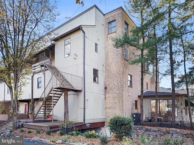 rear view of property with central AC unit