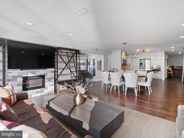 living room with dark hardwood / wood-style flooring