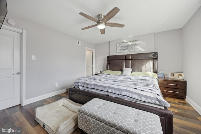 bedroom with ceiling fan and dark hardwood / wood-style floors