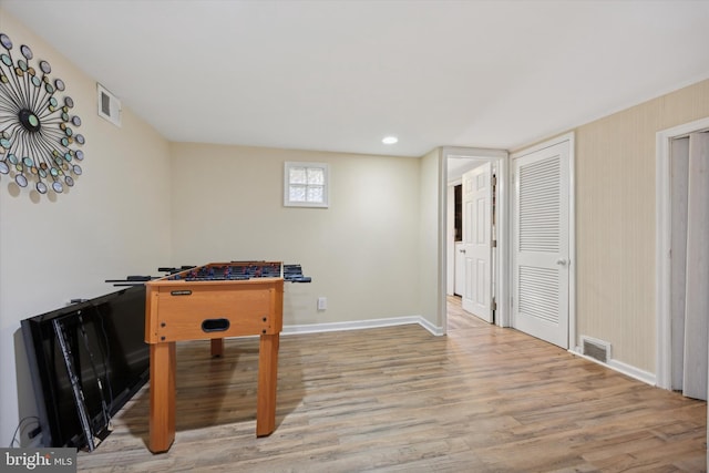 game room featuring light wood-type flooring