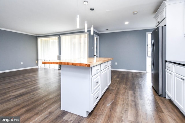 kitchen with white cabinetry, dark wood-type flooring, wood counters, stainless steel fridge, and a kitchen island