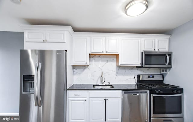 kitchen featuring white cabinets, sink, appliances with stainless steel finishes, and tasteful backsplash