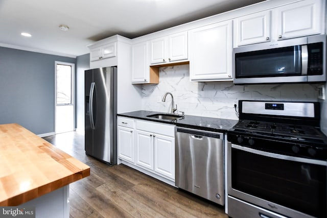 kitchen featuring sink, dark wood-type flooring, wood counters, white cabinets, and appliances with stainless steel finishes