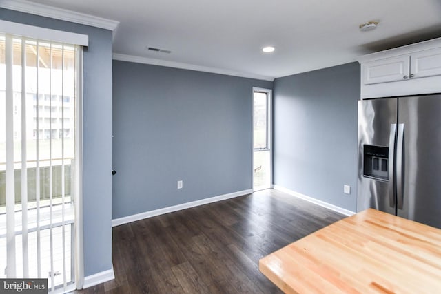 kitchen featuring white cabinets, stainless steel fridge, dark hardwood / wood-style floors, and a healthy amount of sunlight