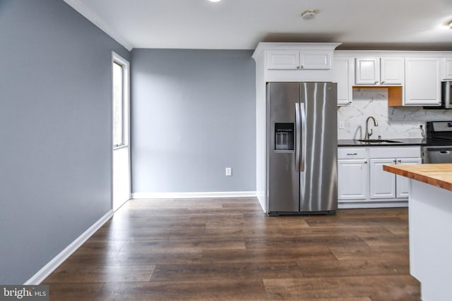 kitchen with white cabinetry, sink, stainless steel appliances, wood counters, and dark hardwood / wood-style floors