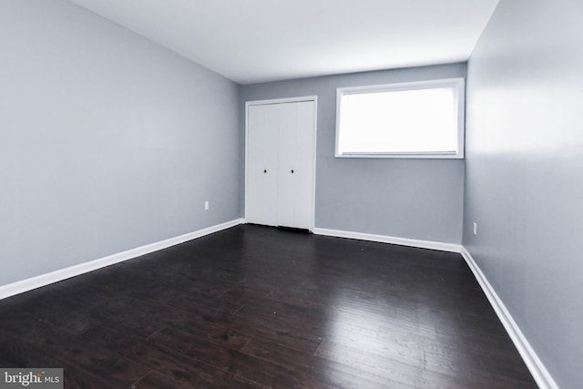 unfurnished bedroom featuring dark hardwood / wood-style flooring