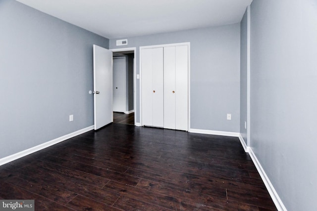 unfurnished bedroom featuring dark hardwood / wood-style floors