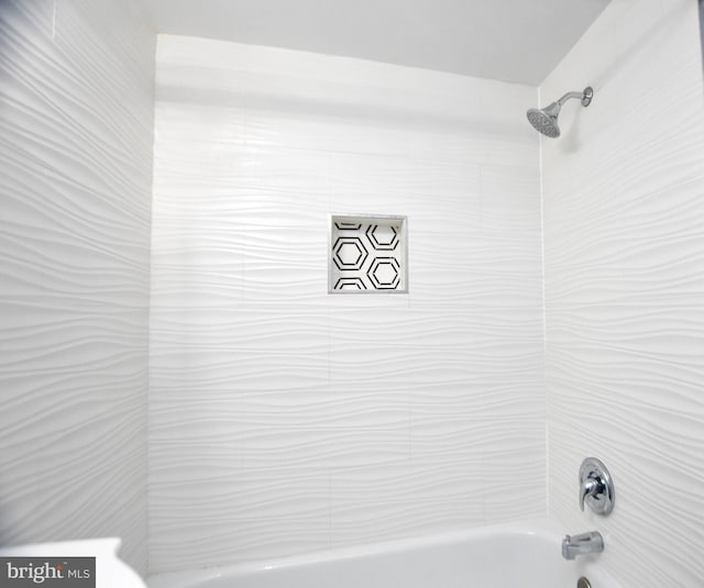 details featuring tiled shower / bath combo