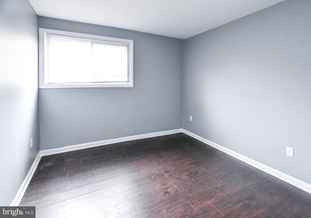 spare room featuring dark hardwood / wood-style flooring