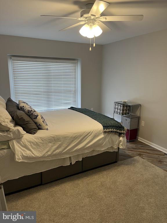 bedroom featuring ceiling fan and wood-type flooring