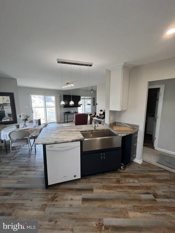 kitchen with dishwasher, hanging light fixtures, kitchen peninsula, dark hardwood / wood-style floors, and white cabinetry