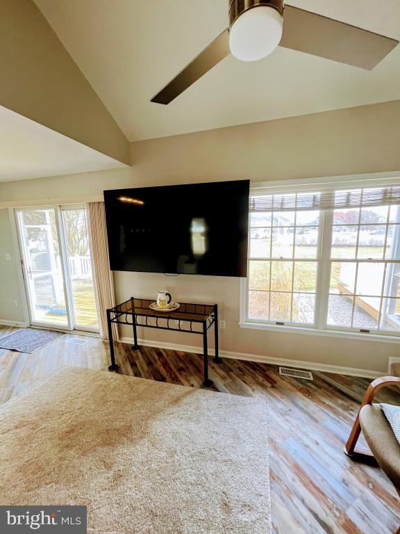 living area featuring hardwood / wood-style floors and lofted ceiling