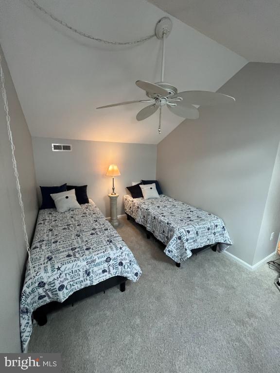 bedroom with carpet, ceiling fan, and lofted ceiling