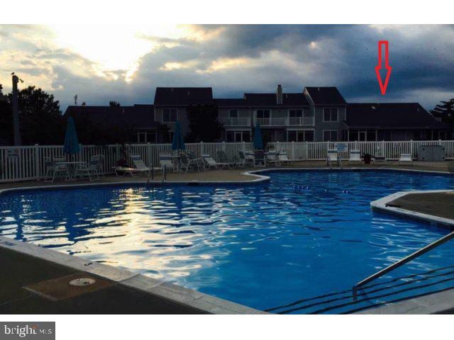 view of pool at dusk