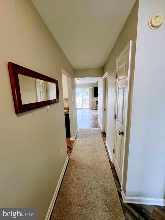 hall with hardwood / wood-style flooring