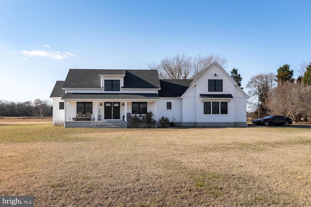 modern inspired farmhouse with a porch and a front yard