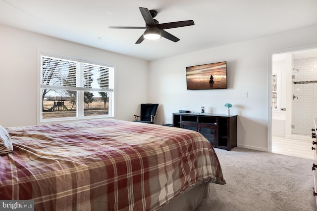 bedroom featuring ensuite bathroom, carpet, and ceiling fan