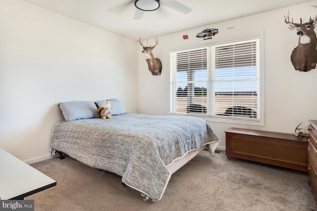 bedroom featuring light colored carpet and ceiling fan