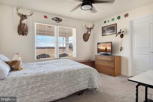 bedroom with ceiling fan and light colored carpet