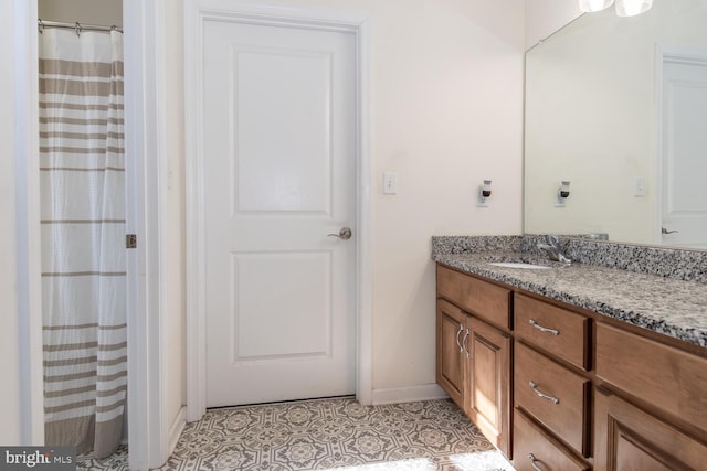 bathroom featuring tile patterned flooring and vanity