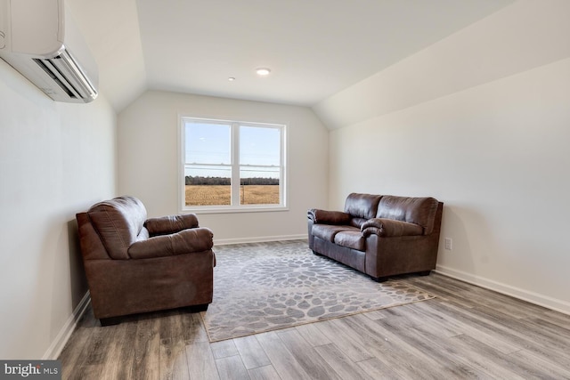 living room with a wall mounted AC, hardwood / wood-style floors, and vaulted ceiling