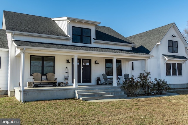 view of front of property with covered porch and a front lawn