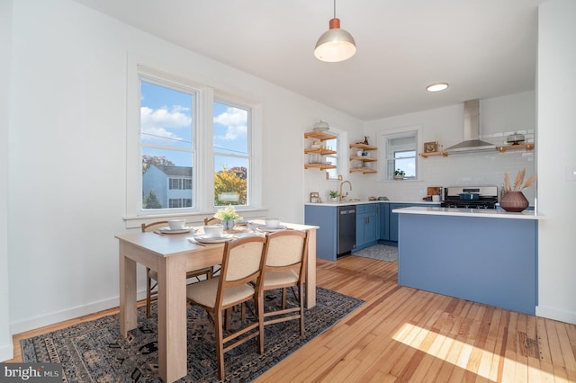 dining room featuring sink and light hardwood / wood-style flooring