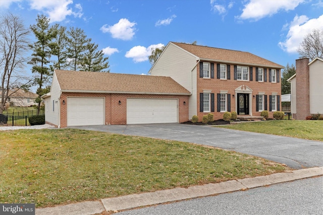 view of front facade featuring a front lawn and a garage