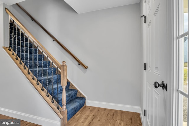 stairway with hardwood / wood-style flooring